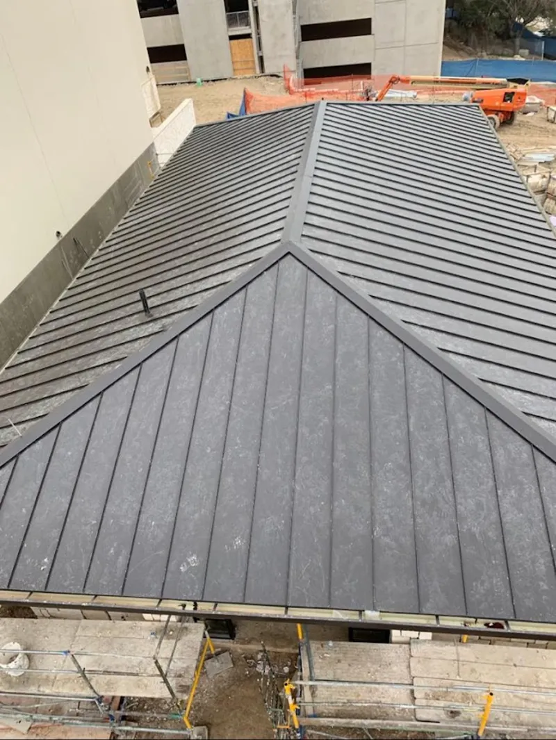 Commercial metal roof construction with crane equipment in White Knoll