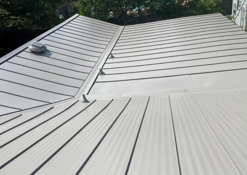 Solar attic fan installed on a metal roof for Roof Ventilation in White Knoll